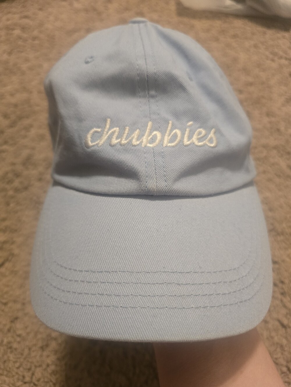 light blue Chubbies relaxed-fit strapback dad hat with white embroidered text